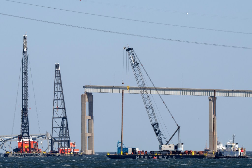 Barges with cranes near damaged Francis Scott Key Bridge in Baltimore, set to begin clearing debris after collapse