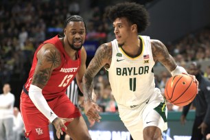 J'Wan Roberts #13 of the Houston Cougars pressures Jalen Bridges #11 of the Baylor Bears in the first half at Foster Pavilion on February 24, 2024 in Waco, Texas.