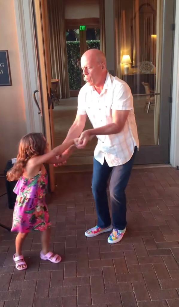 Bruce Willis dancing with a little girl. 