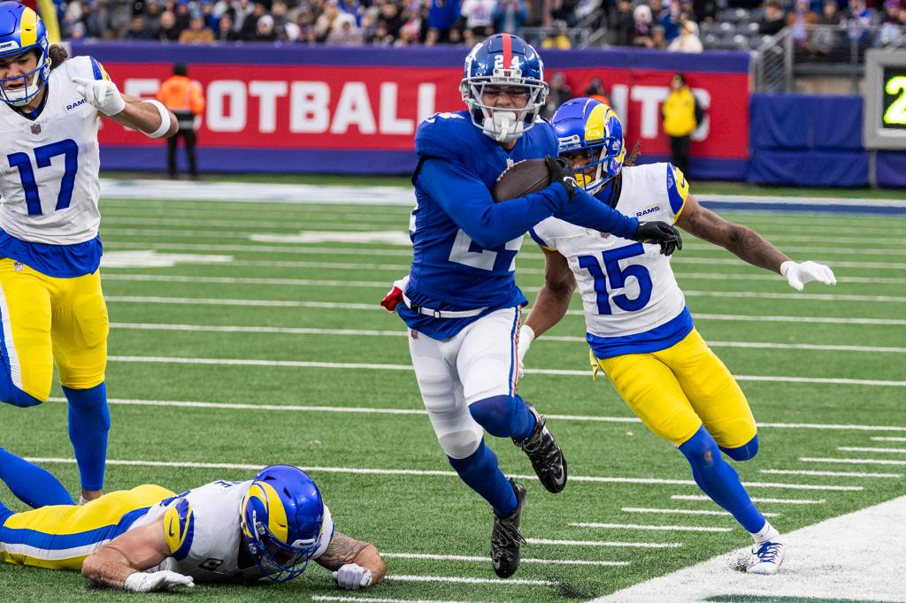 New York Giants safety Dane Belton (24) runs back an interception during the second half against the Los Angeles Rams at MetLife Stadium, Sunday, Dec. 31, 2023, in East Rutherford, New Jersey.