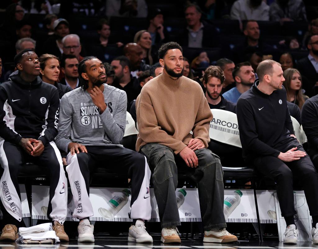 Ben Simmons #10 of the Brooklyn Nets sits on the bench in plain clothes during the first half.