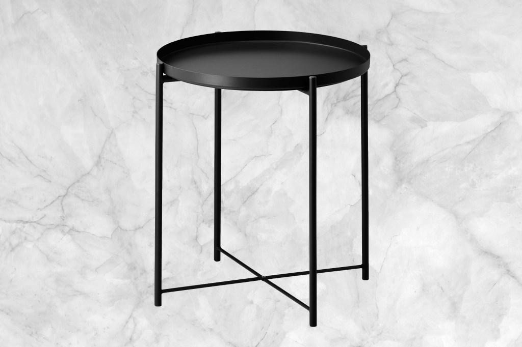 A round black table on a marble background