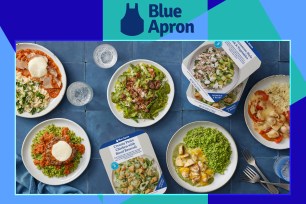 Different Blue Apron dishes and prepared meal containers on a table, against a multicolored background.