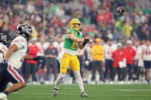 Quarterback Bo Nix #10 of the Oregon Ducks throws a pass during the first half of the Fiesta Bowl.