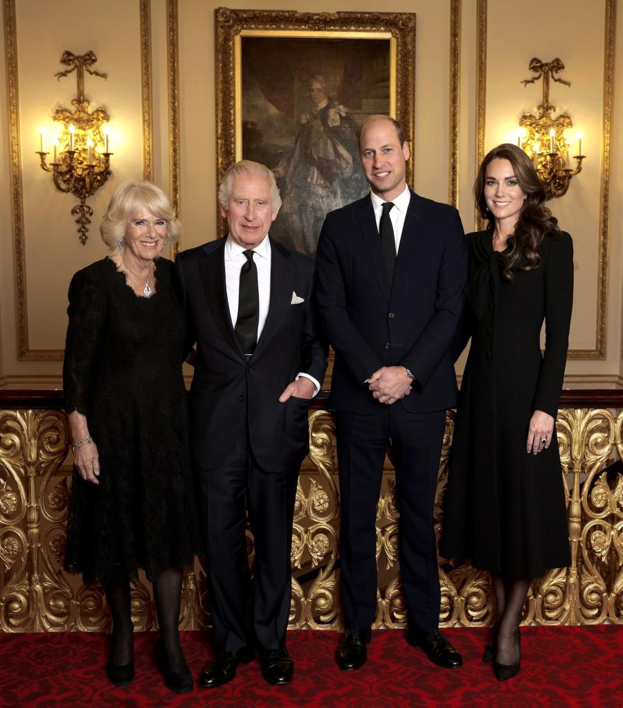 King Charles III and his family members pose for a photo at Buckingham Palace with Camilla, Prince William, and Catherine.