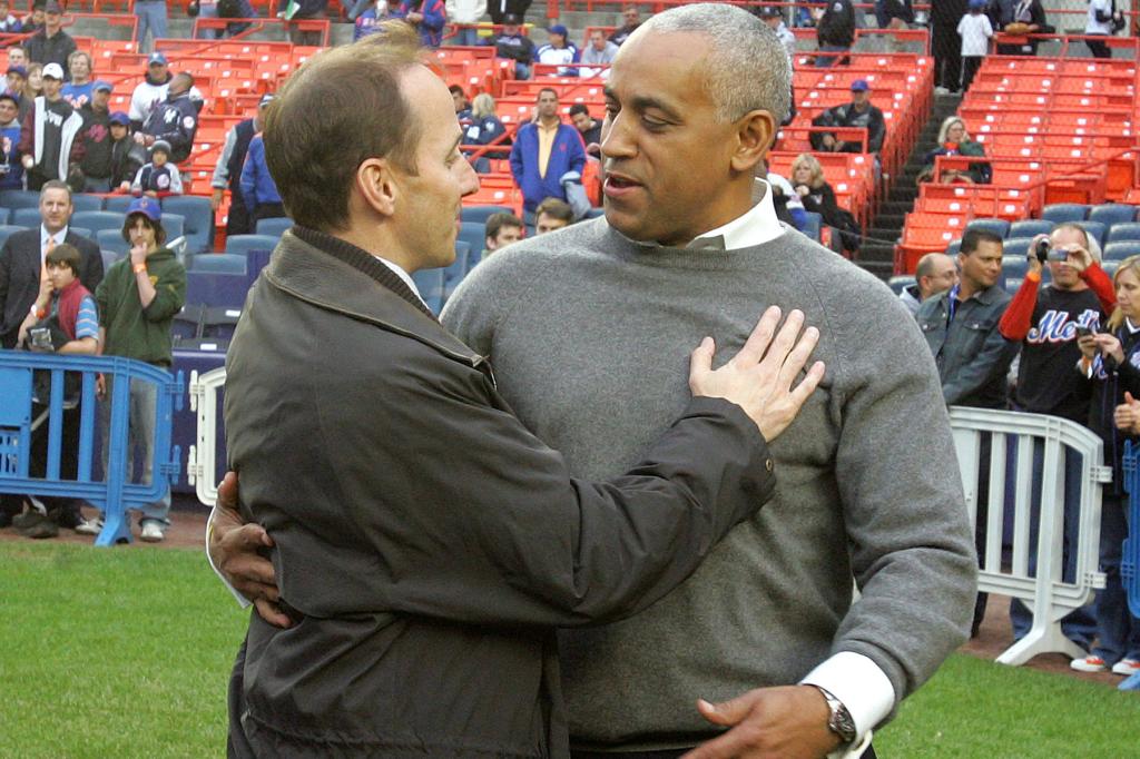 Mets GM Omar Minaya and Yankees GM Brian Cashman meet on the field before the game.