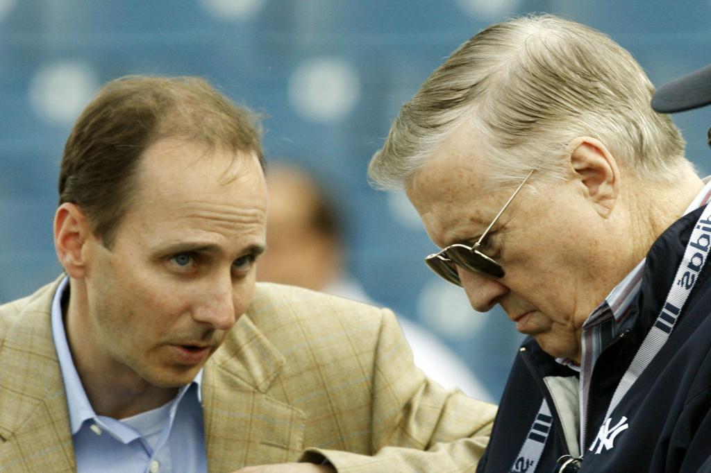 New York Yankees general manager Brian Cashman, left, talks with principal owner George Steinbrenner, before the Yankees spring baseball game against the Boston Red Sox at Legends Field in Tampa, Fla., in this March 22, 2006 file photo.