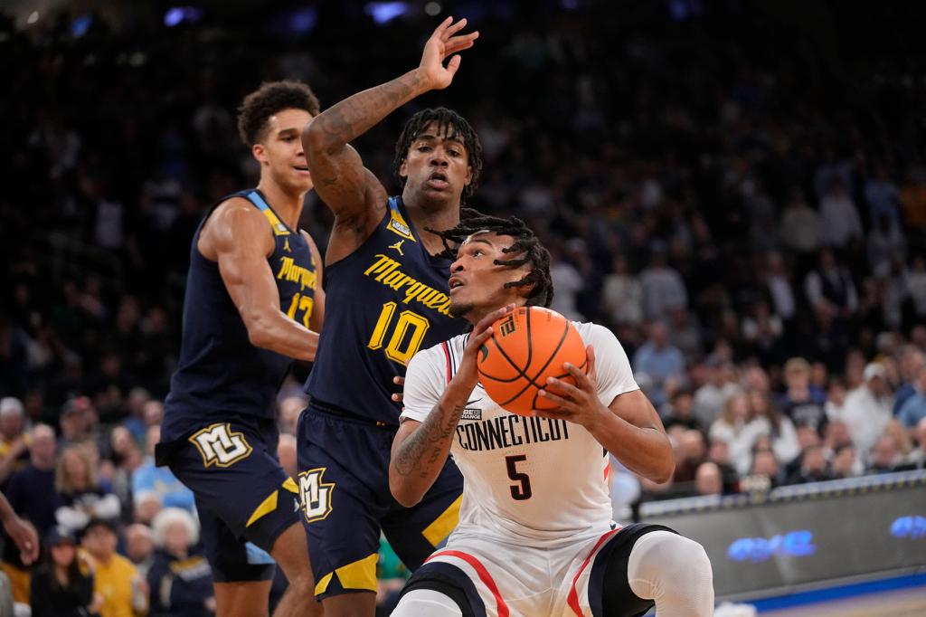 Marquette guard Zaide Lowery (10) and forward Oso Ighodaro (13) guard UConn guard Stephon Castle (5) during the first half of an NCAA college basketball game in the championship of the Big East Conference tournament, Saturday, March 16, 2024, in New York