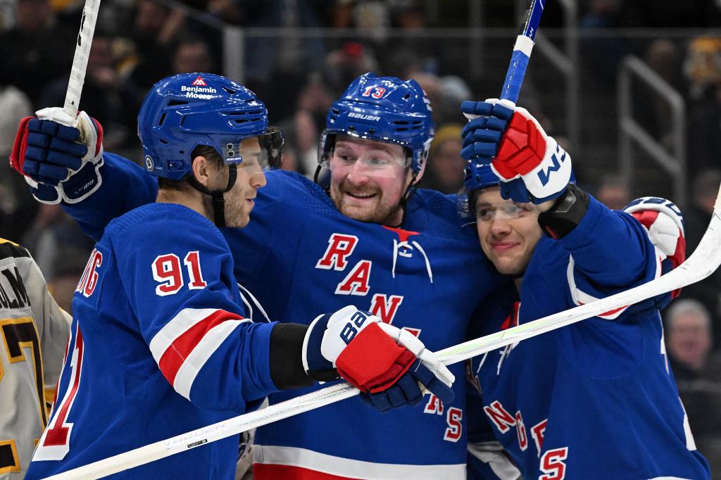 Rangers left wing Artemi Panarin (10) celebrates with left wing Alexis Lafreniere (13) and center Alex Wennberg (91) after scoring a goal against the Boston Bruins.