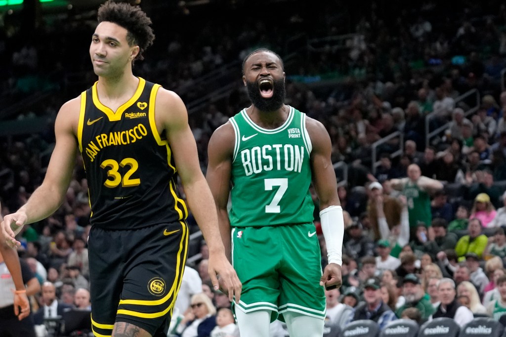 Celtics guard Jaylen Brown (7) celebrates near Golden State Warriors forward Trayce Jackson-Davis (32) after scoring in the second half of an NBA basketball game.