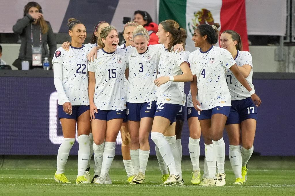 US defender Jenna Nighswonger celebrates with teammates after scoring during Gold Cup women's soccer quarterfinal vs Colombia.