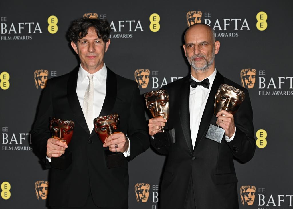  Jonathan Glazer and James Wilson hold BAFTAs.