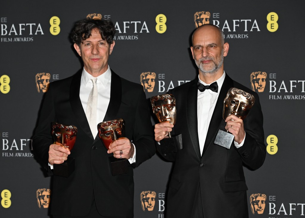  Jonathan Glazer and James Wilson hold BAFTAs.