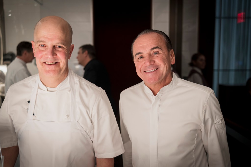 Jonathan Benno (left) and Jean-Georges Vongerichten stand next to each other smiling, wearing chefs whites. 