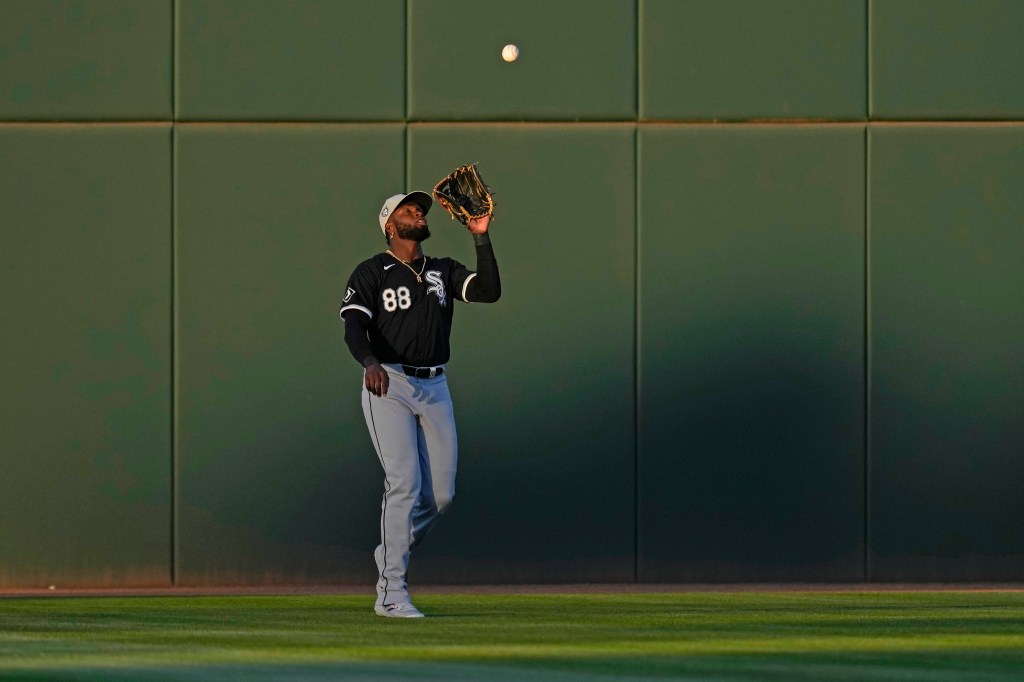 White Sox center fielder Luis Robert Jr. catches a fly ball hit by Cincinnati Reds TJ Friedl the first inning of a spring training baseball game.