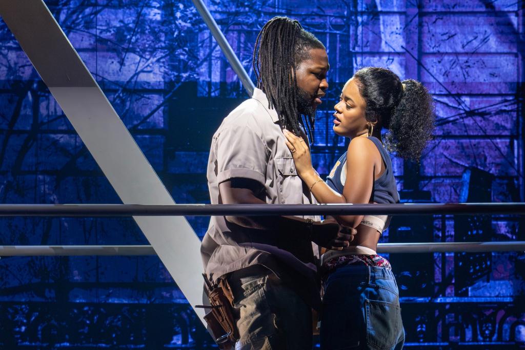 Chris Lee and Maleah Joi Moon standing on stage performing in Hell's Kitchen Musical at The Public Theater.