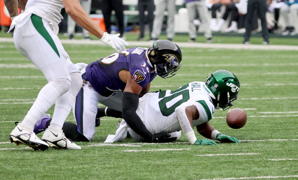 Then-Ravens safety Chuck Clark tackles Jets running back Breece Hall in 2022.