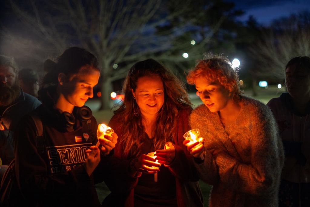 Community members gather at a candlelight vigil in City Park on Monday to honor the life of and grieve the death of Nex Benedict.