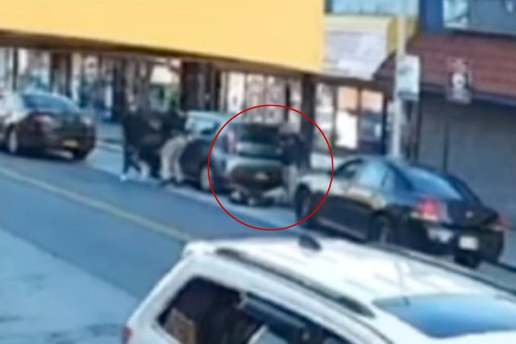 Surveillance video scene from Mott Ave in Far Rockaway of the location where NYPD Officer Jonathan Diller was shot, with a group of people standing beside a road.