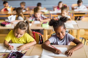 School students writing in their notebooks.