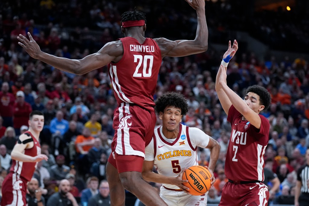 Iowa State guard Curtis Jones (5) cuts between Washington State center Rueben Chinyelu (20) and guard Myles Rice