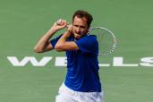 Daniil Medvedev of Russia hits a backhand against Carlos Alcaraz of Spain during the final of the BNP Paribas Open at Indian Wells Tennis Garden.