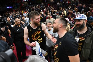 Dean Wade #32 of the Cleveland Cavaliers talks with Travis and Jason Kelce after the Cavaliers defeated the Boston Celtics.