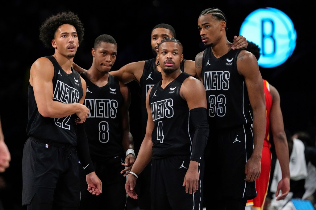 Nets' Jalen Wilson (22) huddles with teammates Lonnie Walker IV (8), Dennis Smith Jr. (4), Nic Claxton (33) and Mikal Bridges