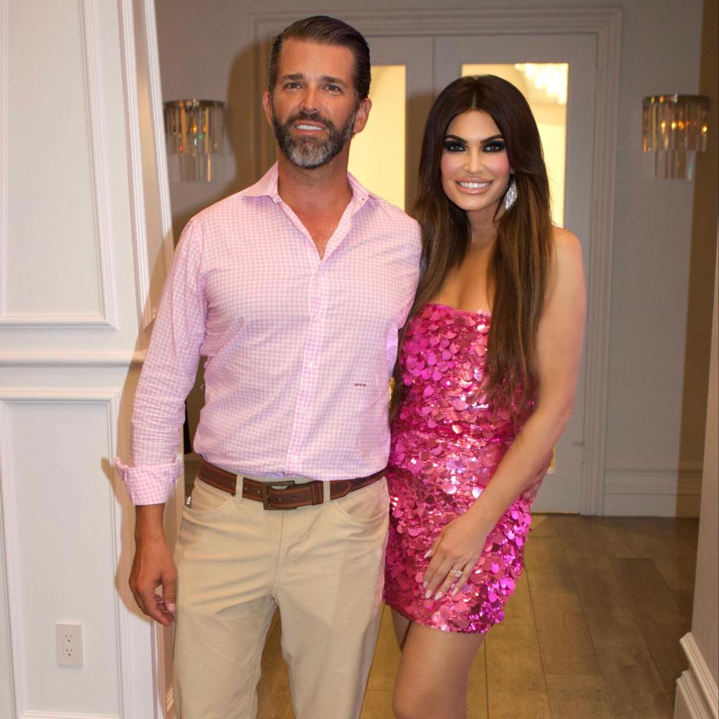 Donald Trump Jr. and Kimberly Guilfoyle standing in a hallway