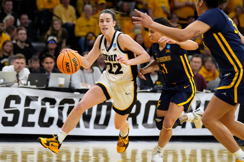 Iowa guard Caitlin Clark (22) drives past West Virginia guard JJ Quinerly (11) in the second half of a second-round college basketball game in the NCAA Tournament, Monday, March 25, 2024, in Iowa City, Iowa.  