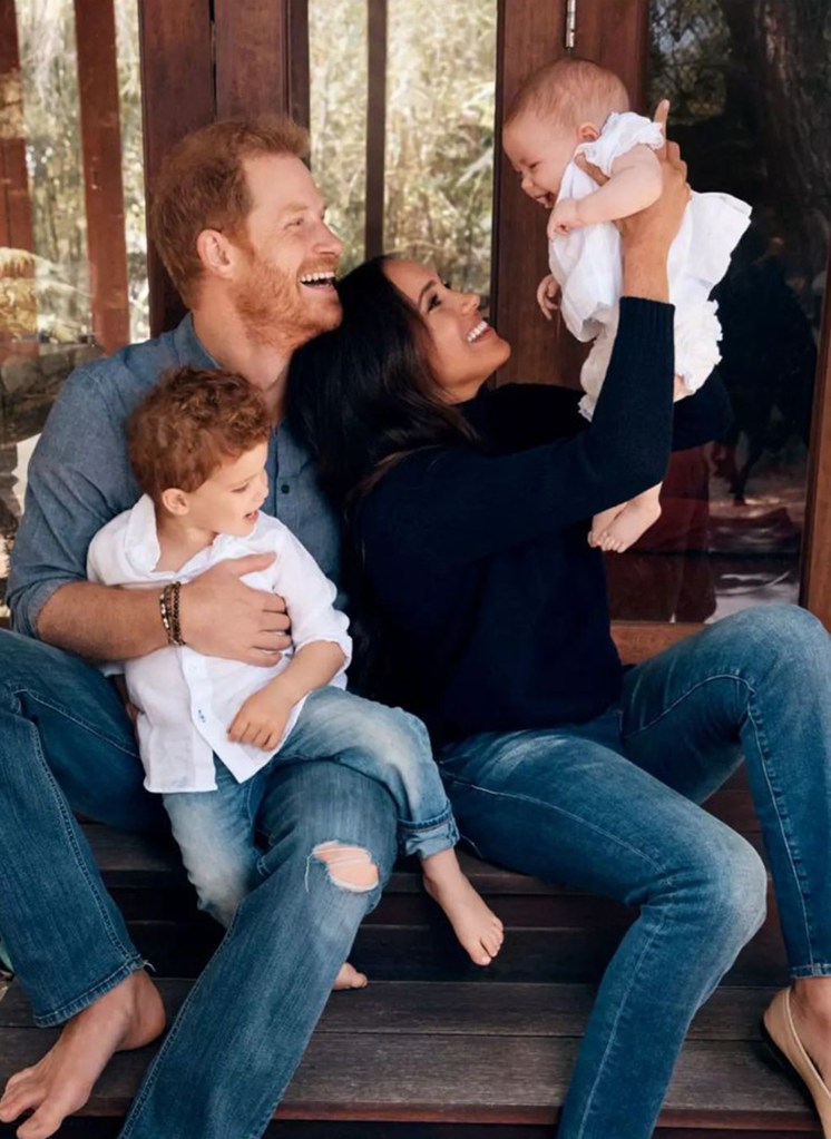A man and woman holding a baby, likely the Duke and Duchess of Sussex with their daughter Lilibet.