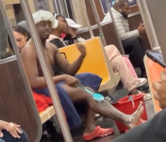 Eli, a social media content creator and streamer bathes on the subway