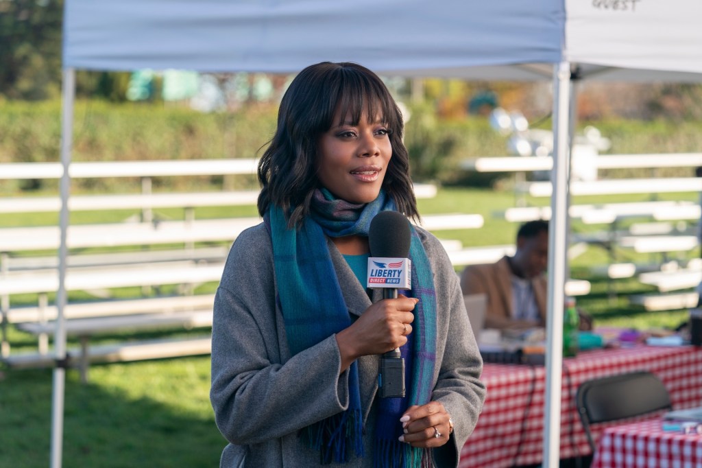 Christina Elmore holding a mic. 