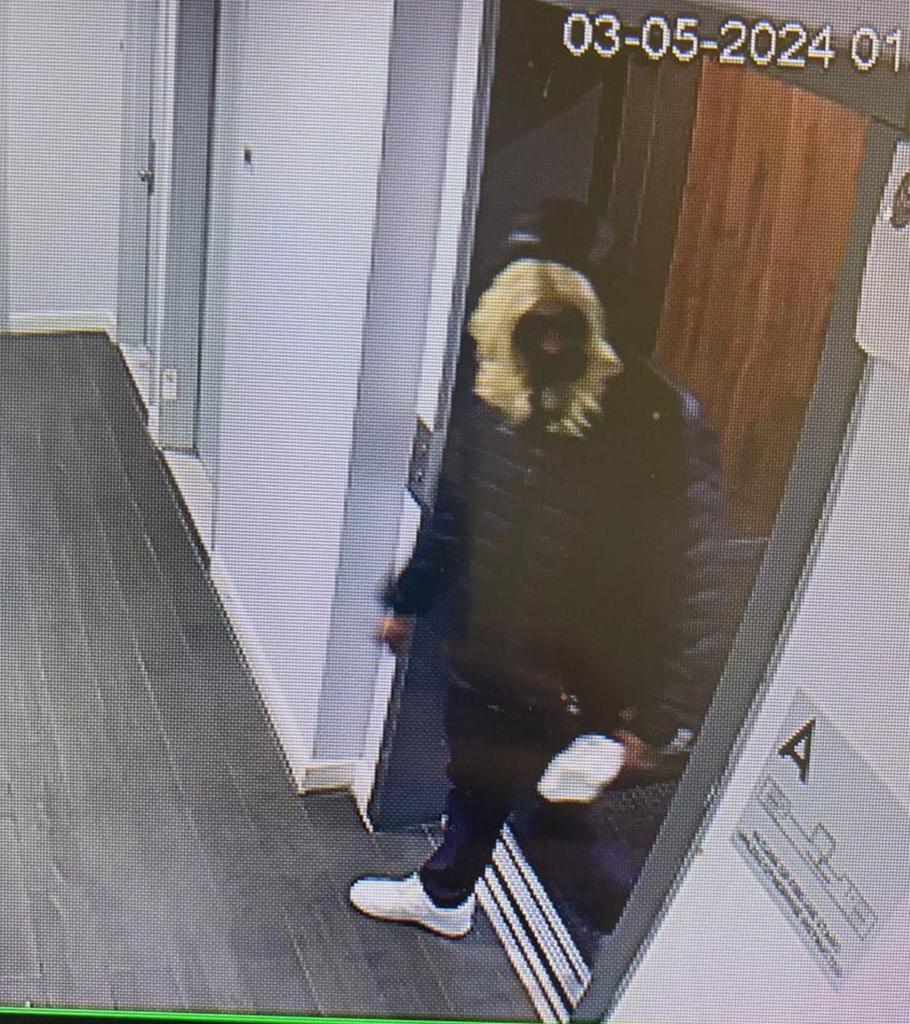 Johnson allegedly in the apartment building while wearing a blond wig.