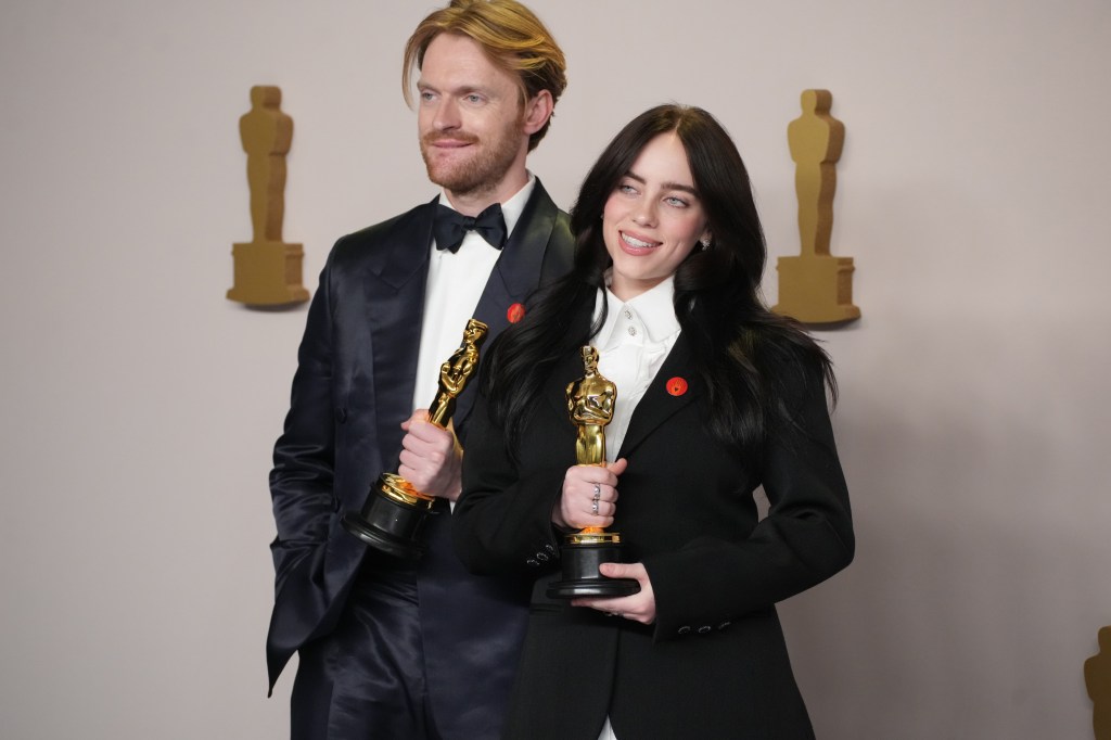 Finneas O'Connell and Billie Eilish pose with their Oscars.