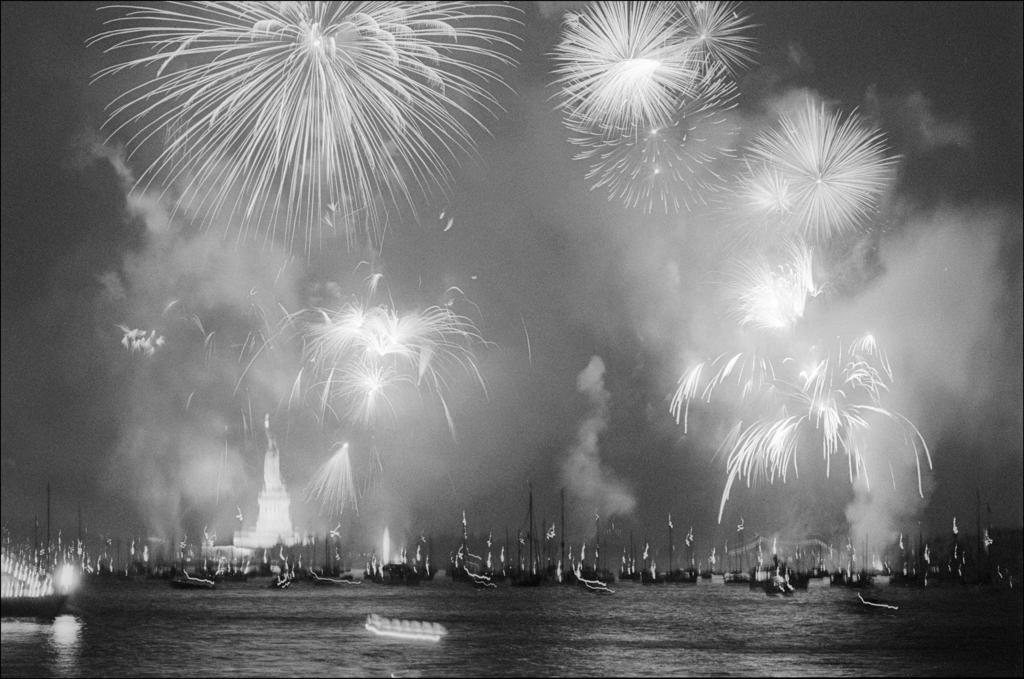 Fireworks fill the night sky over New York Harbor and the Statue of Liberty in celebration of America's Bicentennial 50 years ago.