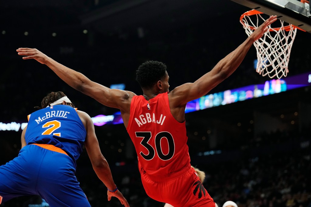 Knicks guard Miles McBride (2) fouls Toronto Raptors guard Ochai Agbaji (30) during the first half