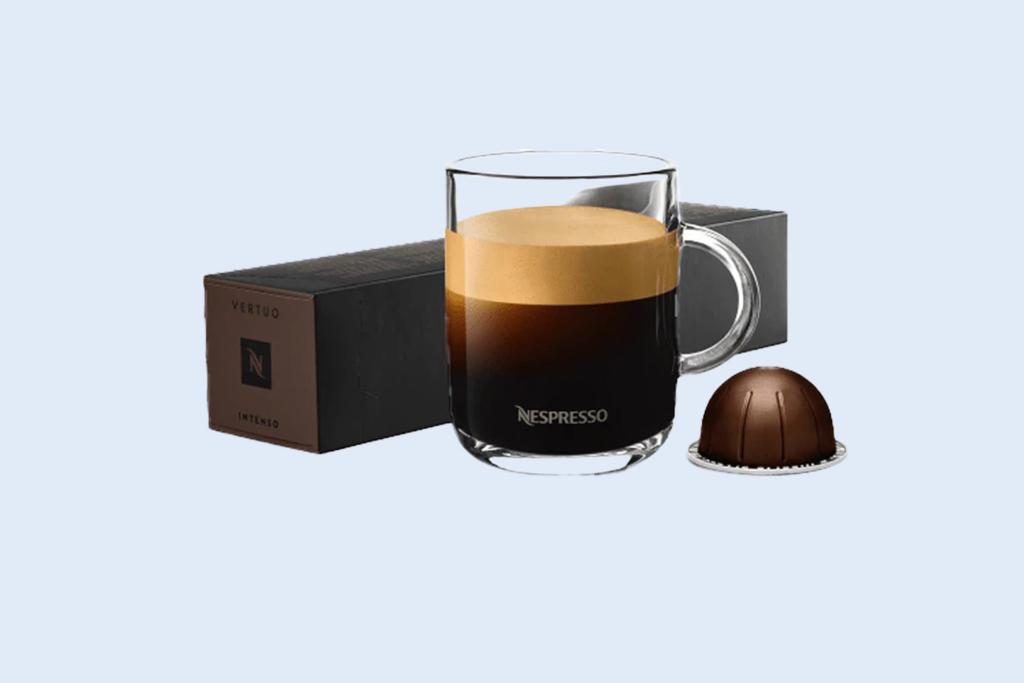 Image of a cup of Nespresso coffee next to a pack of Nespresso pods