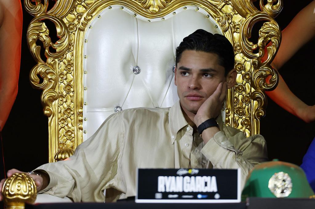 Ryan Garcia sits on a makeshift throne during the press conference for his fight against Devin Haney at Palladium Times Square on February 27, 2024 in New York City. Haney will be defending his WBC Super Lightweight title against Garcia when they fight at the Barclay Center on April 20, 2024 in New York City 