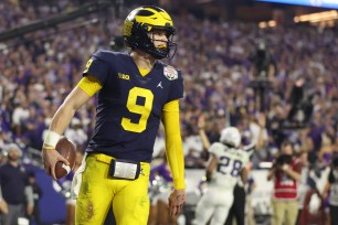 J.J. McCarthy of the Michigan Wolverines reacts after rushing for a touchdown during the third quarter against the TCU Horned Frogs in 2022.