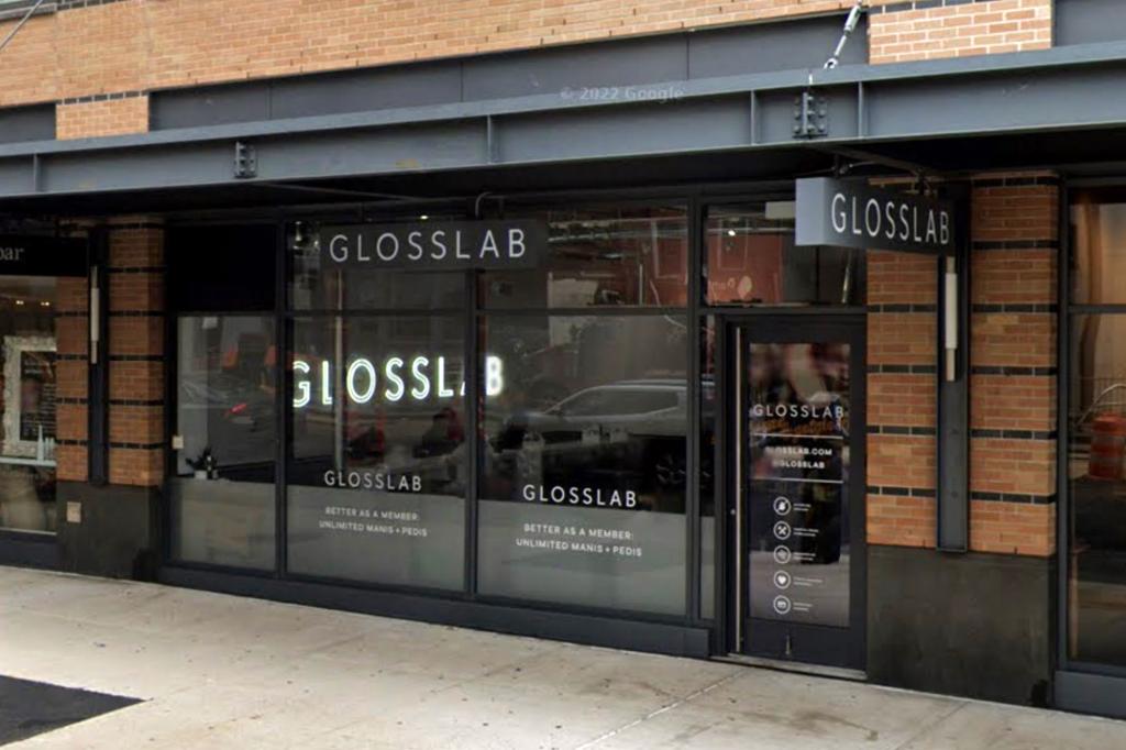 Group of people walking on the sidewalk outside the GLOSSLAB nail salon in Manhattan.