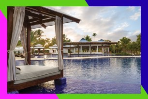 A swimming pool area with a canopy and patio umbrellas