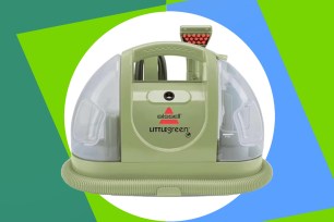 a green vacuum cleaner with a round tube