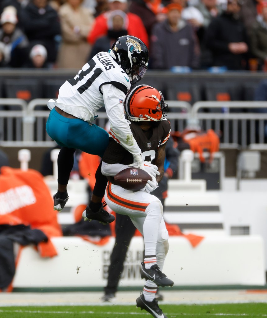 Jacksonville Jaguars cornerback Darious Williams (31) hits the ball away from Cleveland Browns wide receiver Elijah Moore (8) during the first half of an NFL football game, Sunday, Dec. 10, 2023, in Cleveland. 