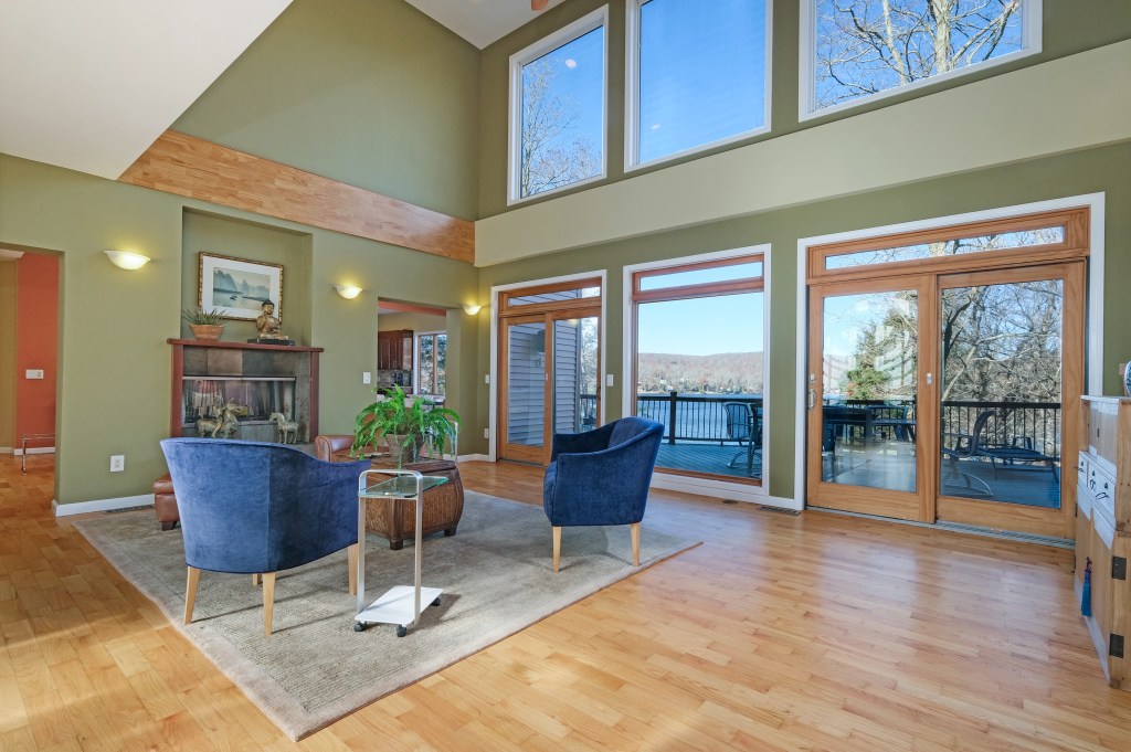 The living room sports floor-to-ceiling windows looking out on the water.