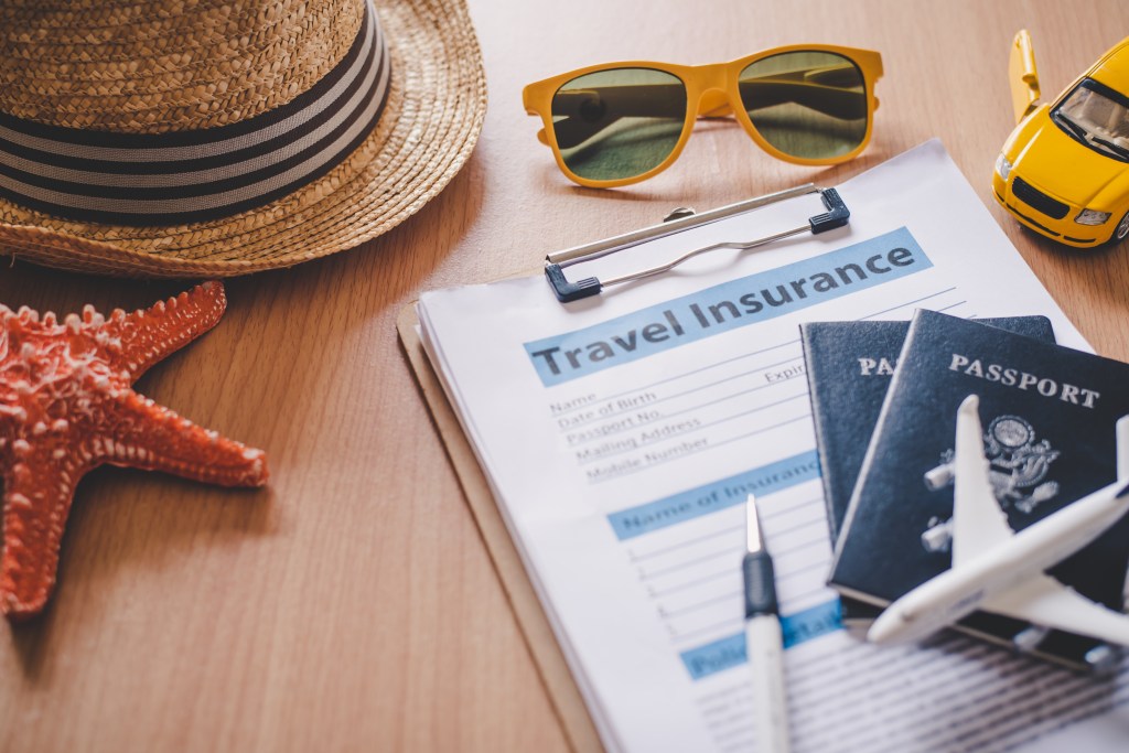 a travel insurance form with sunglasses and a hat
