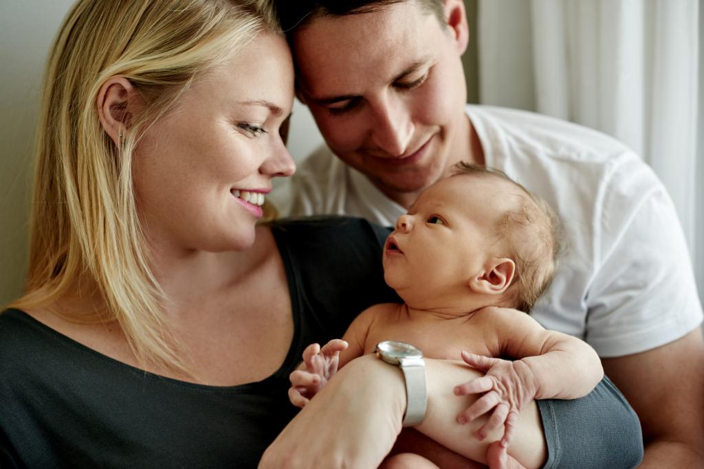 Shot of a young married couple spending time with their newborn baby.