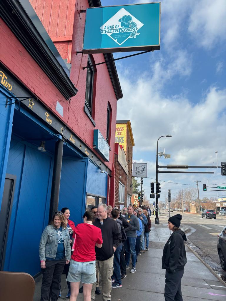 A line waits outside "A Bar of Their Own" on a Caitlin Clark game day.