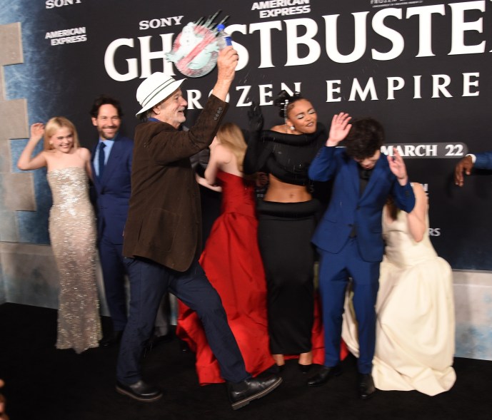 Bill Murray, Emily Alyn Lind, Paul Rudd, Finn Wolfhard, Mckenna Grace, Celeste O'Connor, Logan Kim, Gil Kenan, Carrie Coon, Ernie Hudson, Dan Aykroyd, and Jason Reitman posing for a photo at the premiere of "Ghostbusters: Frozen Empire" in New York City.