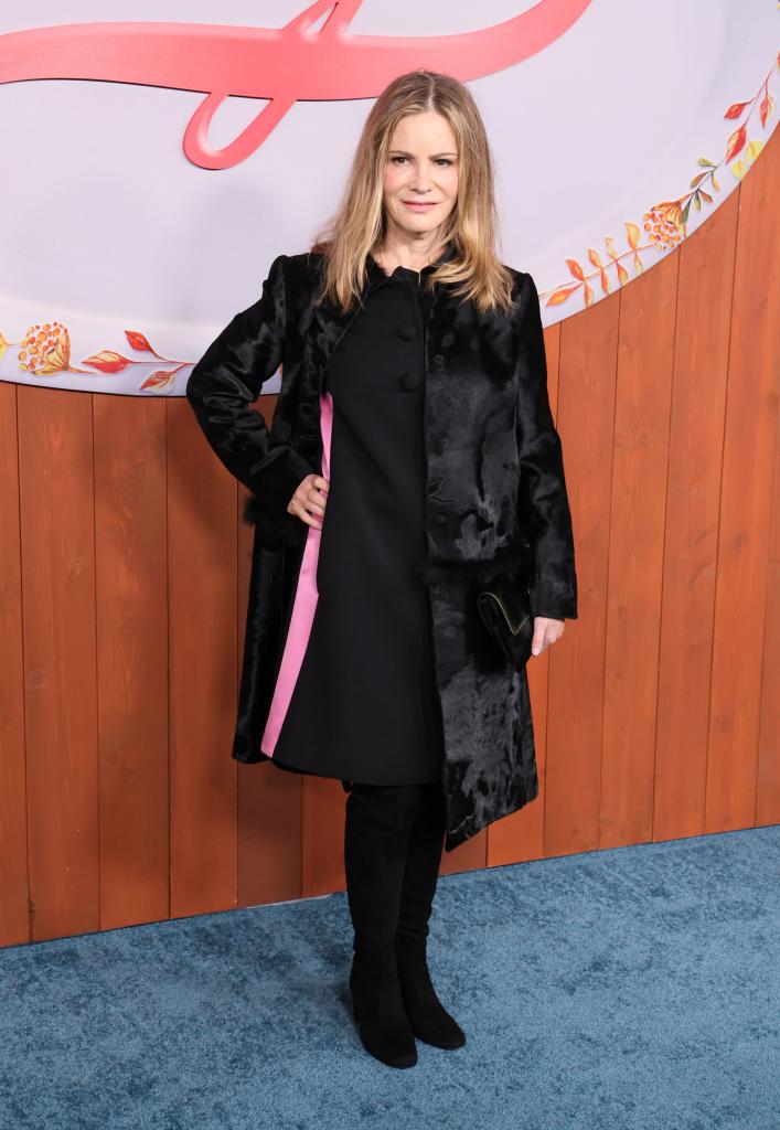 Jennifer Jason Leigh in a black dress and coat at the premiere of "Fargo" in November 2023.